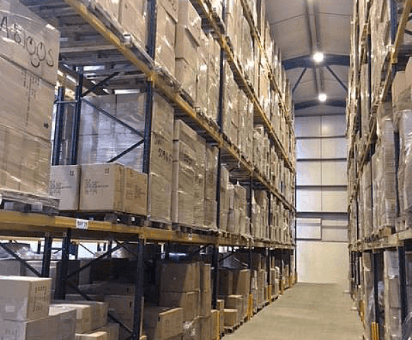 Modern UK warehouse interior with stacked pallets and automated fulfilment systems